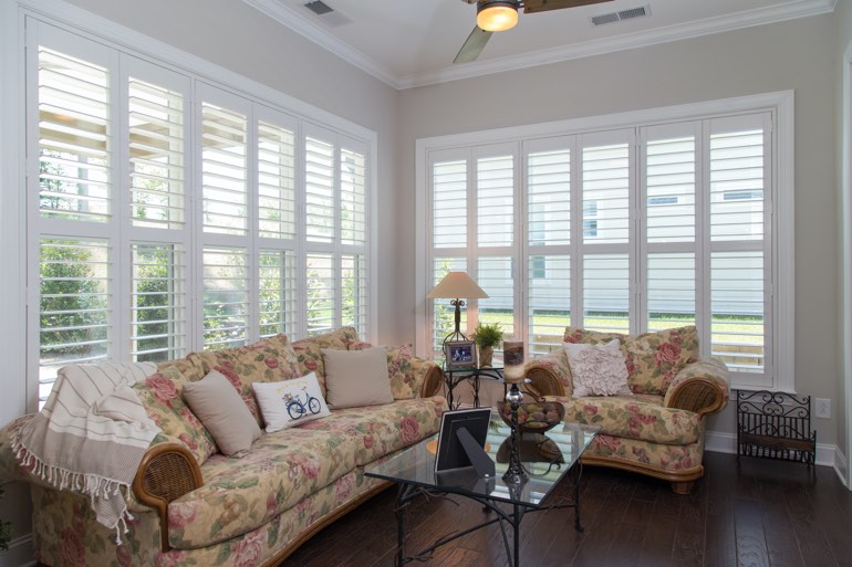Airy sunroom with interior shutters in Fort Myers.